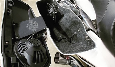  A motorcycle with its side panel removed, revealing internal components including speakers and wiring.